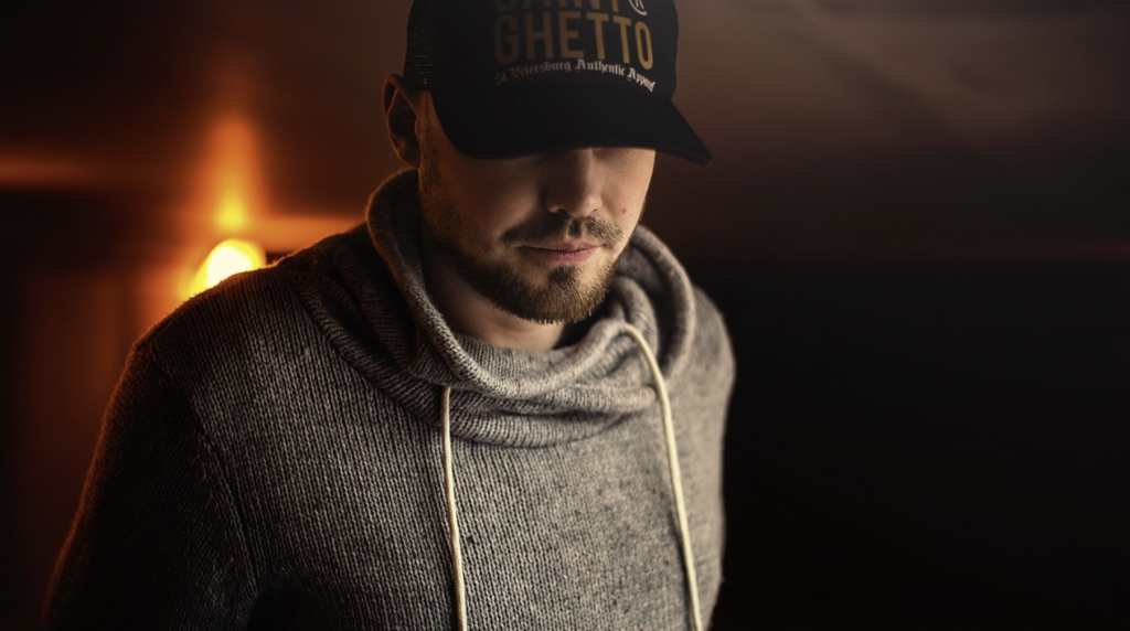 A man sitting alone in a dark room representing why social isolation fuels porn addiction.