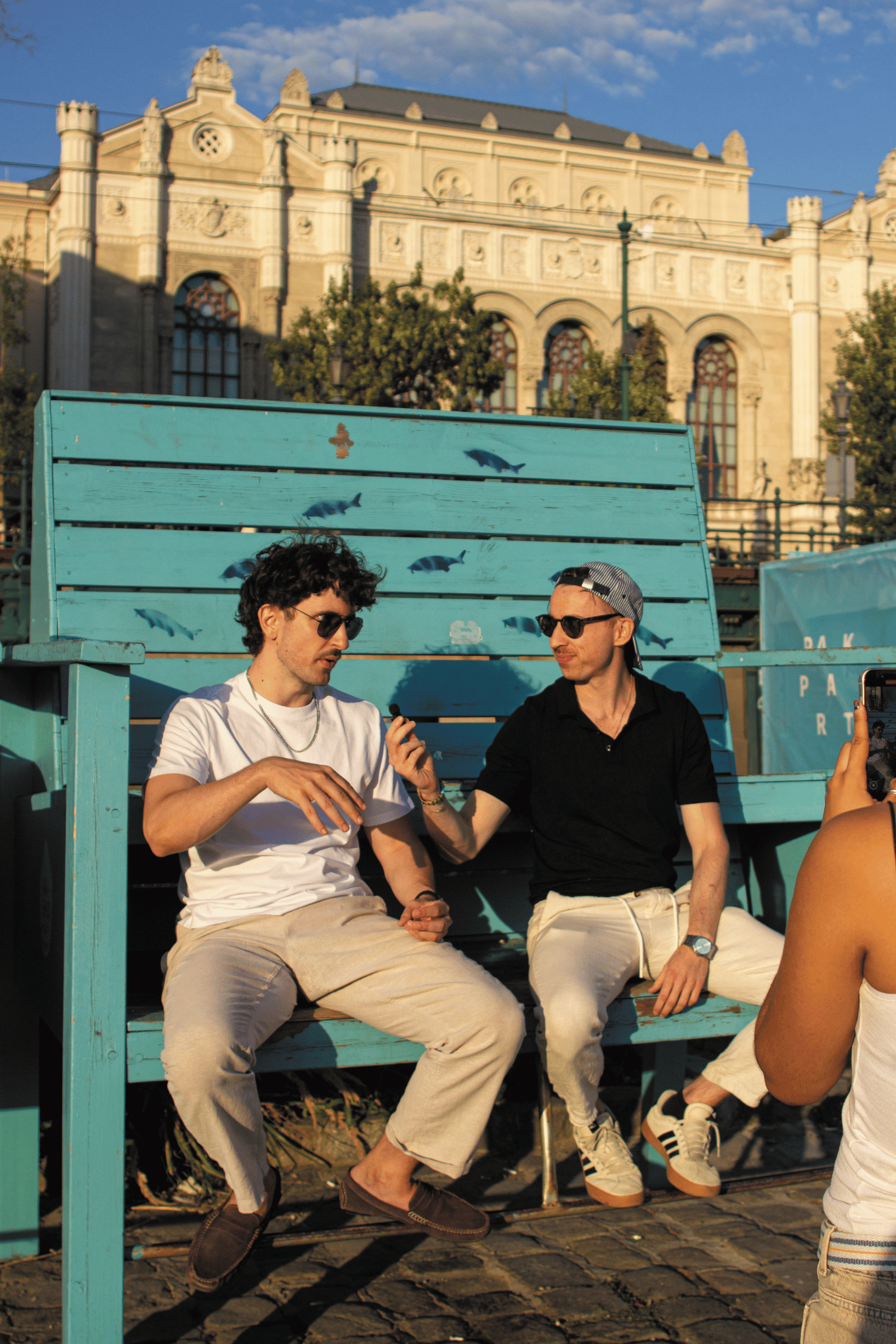 Nick Ambrus in conversation on a bench outdoors
